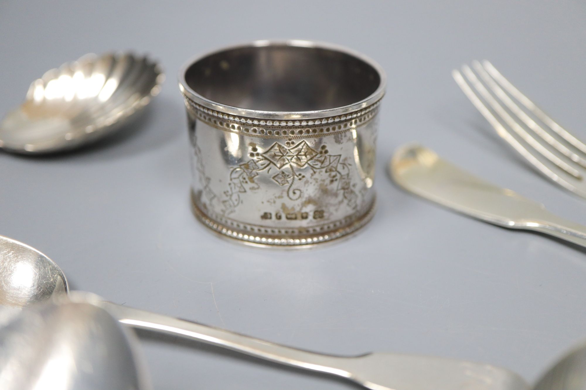 A group of assorted 19th century silver flatware including two caddy spoons (one Scottish) and a napkin ring,